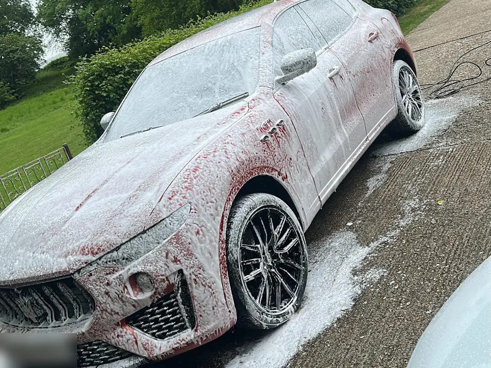 Red Maserati Levante covered in snow foam during a full valet by JJ Valets, Chichester