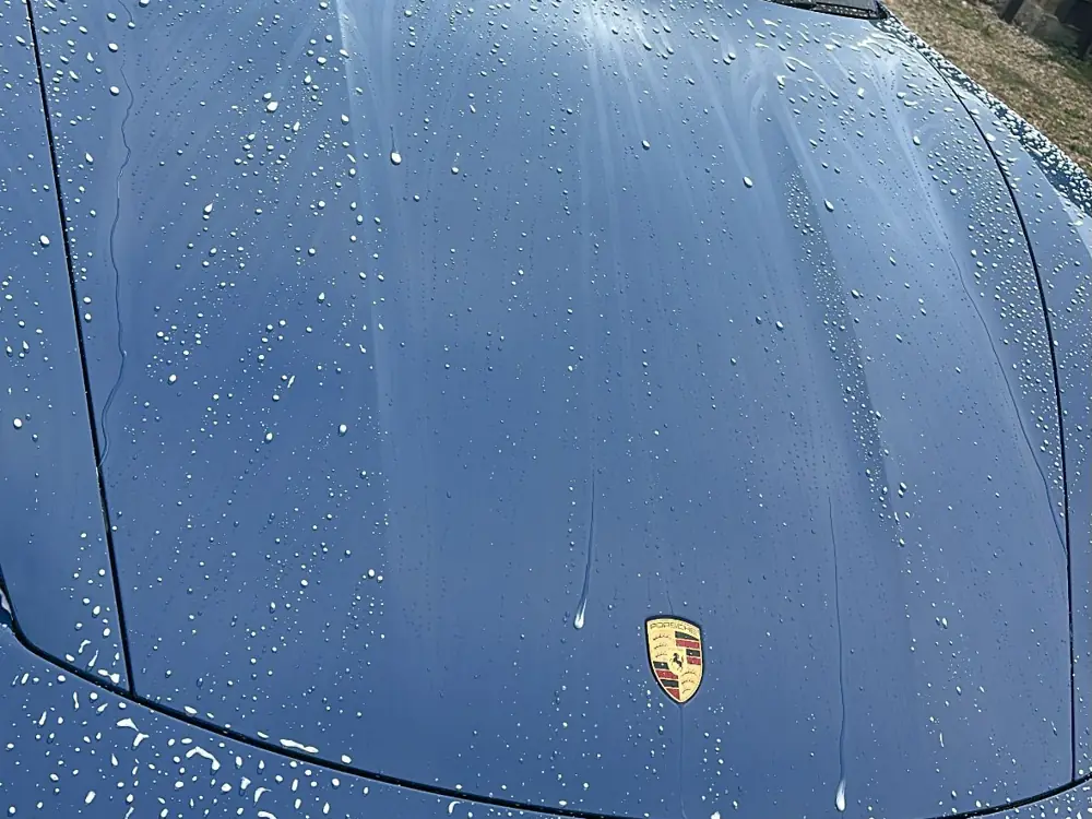 Water beading on a blue Porsche after paint protection by JJ Valets, Chichester